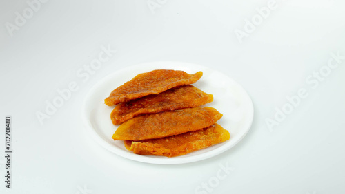Boli on White Plate, Infused with the heavenly aroma of ghee and spices, Sweet Boli is a sensory delight that tantalizes the taste buds and delights the senses.