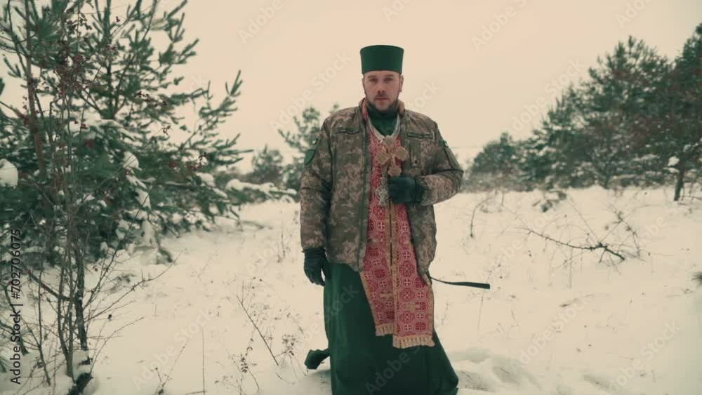 Chaplain in military uniform of the Ukrainian army. Portrait of a young chaplain in a snowy open space. Ukraine's war with Russia. Chaplain in military uniform of the Ukrainian army. Portrait of a young chaplain in a snowy open space. Ukraine's war with Russia.