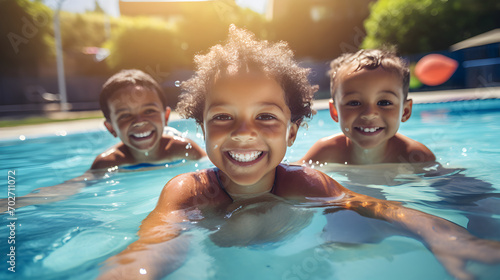 Diverse young children enjoy swimming lessons in pool, learning water safety skills