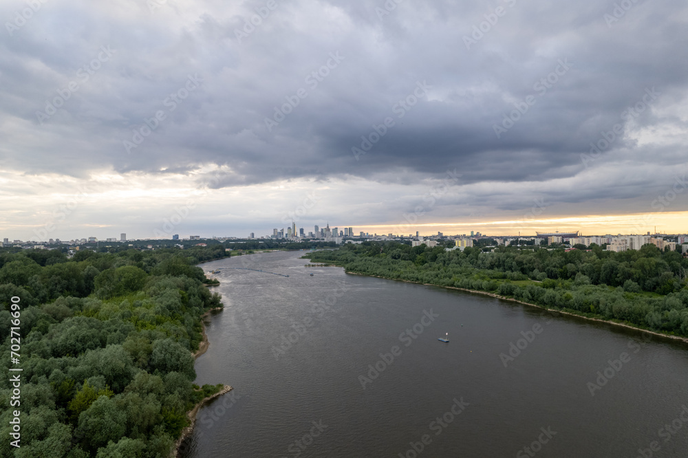 From a drone's perspective, the Vistula River in Warsaw unveils its scenic beauty, winding through the cityscape. From a drone's perspective, the Vistula River in Warsaw unveils its scenic beauty, winding through the cityscape.