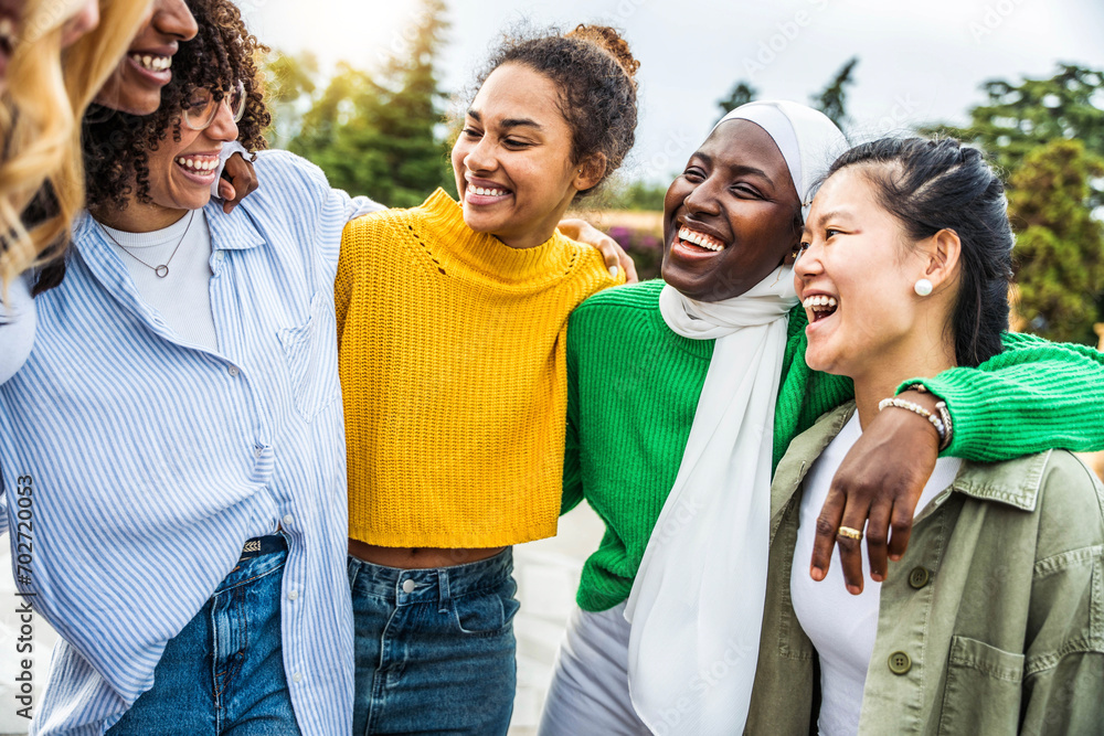 © Davide Angelini - Multi ethnic group of young women hugging outside - Happy girlsfriends having fun laughing out loud on city street - Female community concept with cheerful girls standing together - Women  power