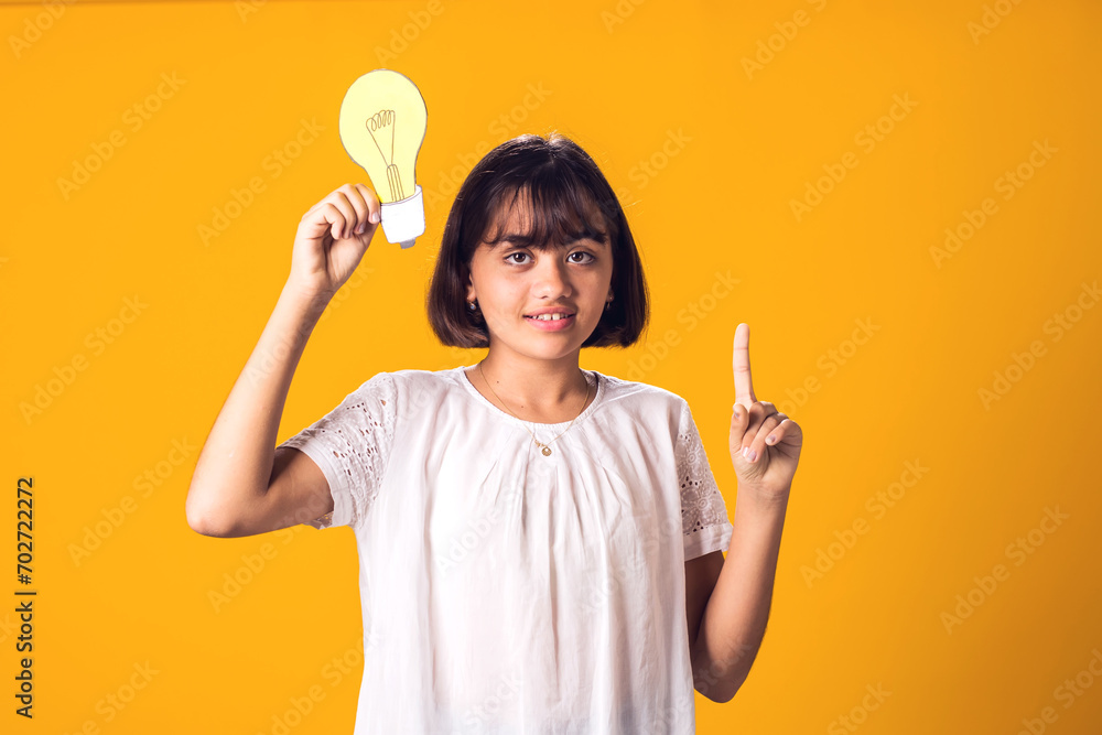 Child girl holding paper bulb. Success, motivation, winner, genius, idea concept Child girl holding paper bulb. Success, motivation, winner, genius, idea concept