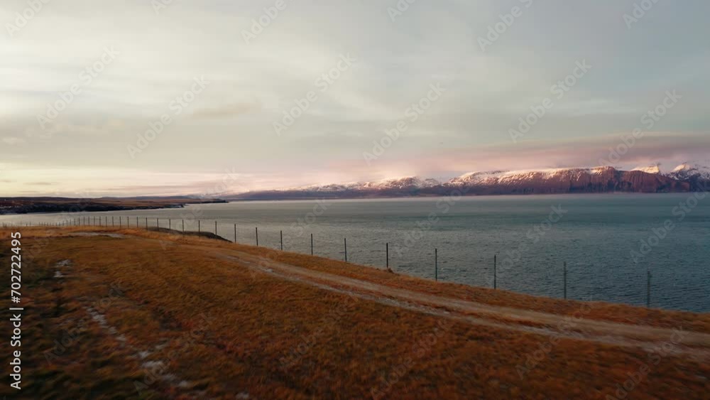 Ocean shore with snowy mountains in the background Ocean shore with snowy mountains in the background