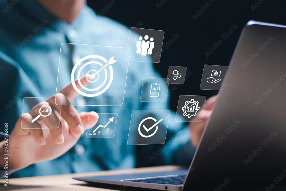 Targeting business concept. Businessman use laptop with target icons for business objective. Strategic planning for business growth and target customer group. set up business objective target goal. Targeting business concept. Businessman use laptop with target icons for business objective. Strategic planning for business growth and target customer group. set up business objective target goal.