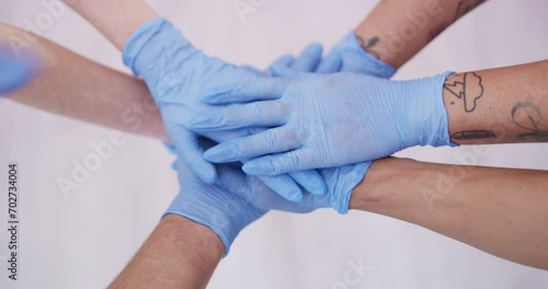 Top of hands stack, gloves for health and support in team with people for hygiene and wellness in studio. Healthcare, safety and protection with collaboration for solidarity on white background photo