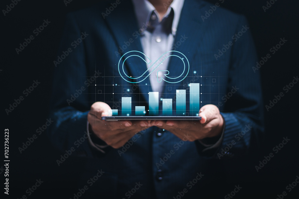 Businessman with infinity symbol and business profit revenue growth graph for Circular economy with infinite concept. - obrazy, fototapety, plakaty 