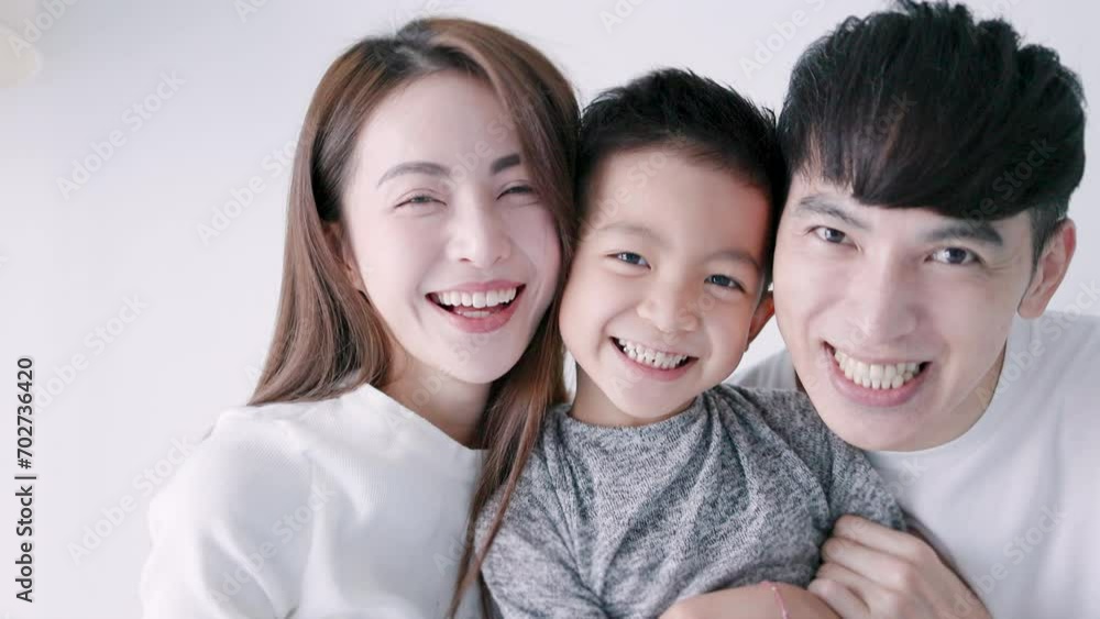 Happy family and child hugging and looking at camera Happy family and child hugging and looking at camera