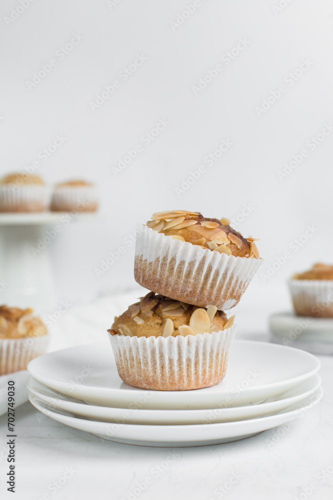 almond muffins on a white plate, homemade bakery style almond muffins on a white background almond muffins on a white plate, homemade bakery style almond muffins on a white background