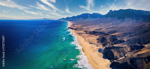 Aerial, panoramic view of the beautiful, unspoiled Cofete beach on the volcanic island of Fuerteventura, Canary Islands, Spain.