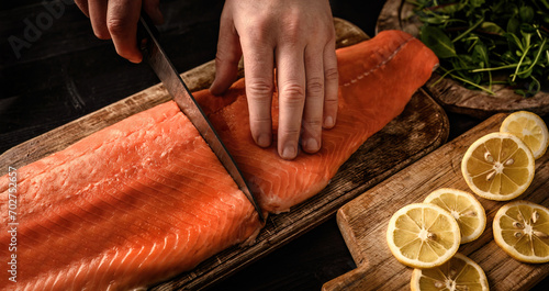 Chief hands preparing salmon fillet