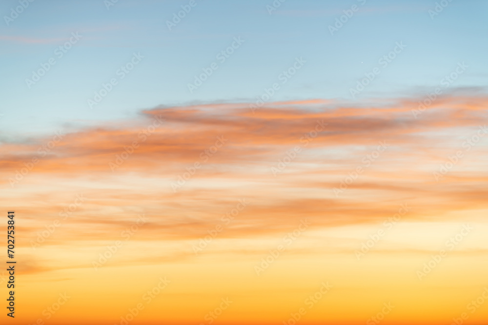 The dramatic colors of the sunset in the sky gradient from blue to orange.