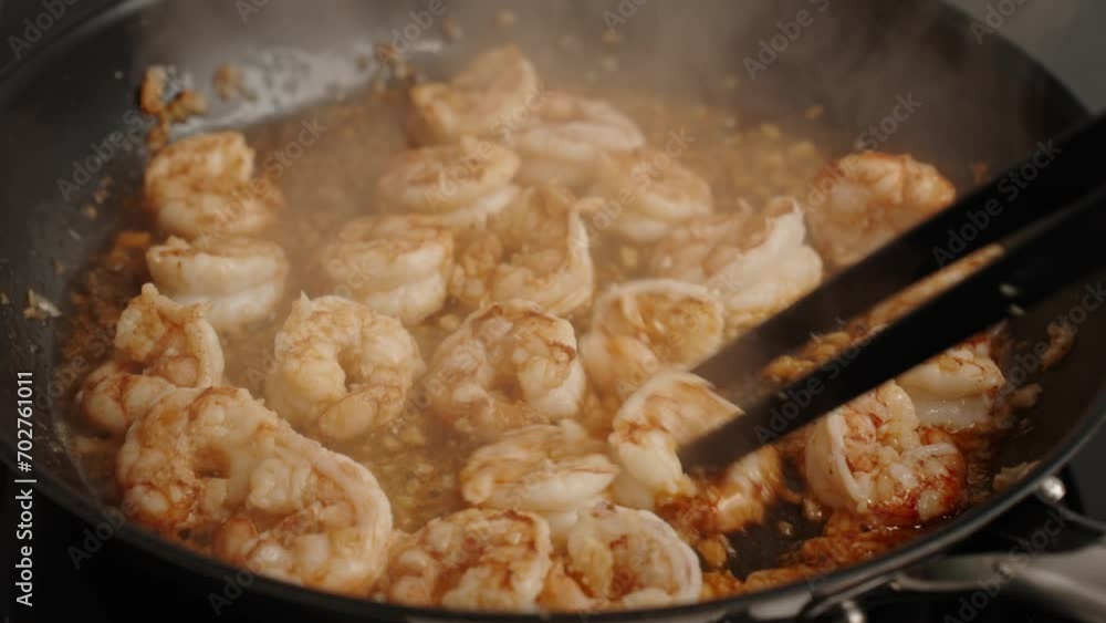 Process of fries shrimp in pan with olive oil and garlic in the kitchen. Preparing meal with prawn. Cooking seafood. Process of fries shrimp in pan with olive oil and garlic in the kitchen. Preparing meal with prawn. Cooking seafood.