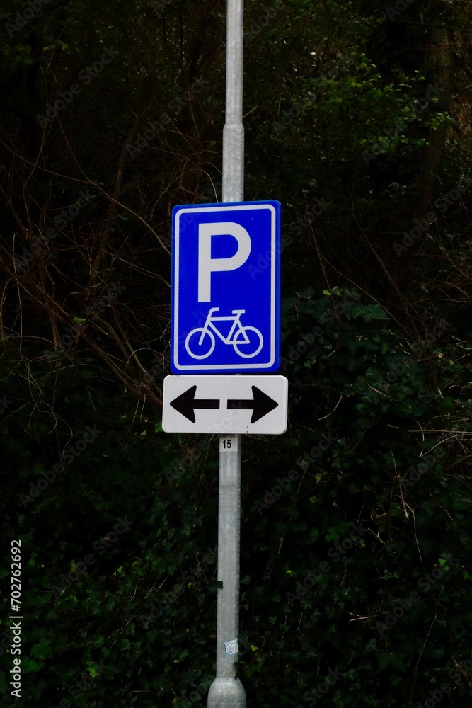 Empty blue parking sign with arrows pointing to both sides Empty blue parking sign with arrows pointing to both sides