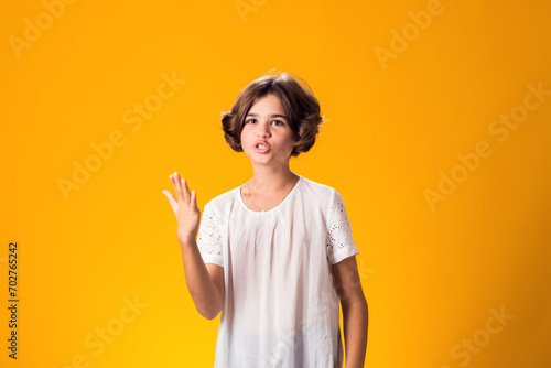 Tableau sur toile Indignant angry expressive confused kid girl over yellow background