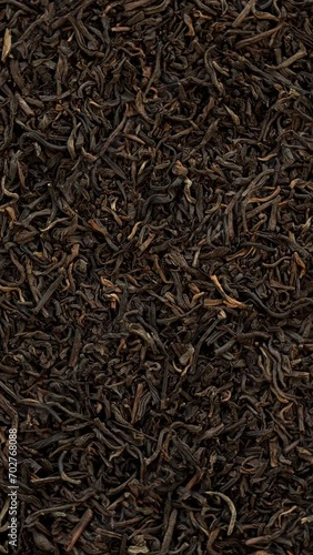 Top view of unpressed pu-erh tea background texture. Table spin. Vertical video. photo