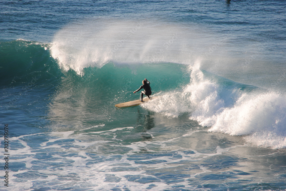 Professional surfer rides a wave in the ocean. Sopelana beach near Bilbao (Basque Country). Men catching waves in ocean. Tail slide water surf, action water board sport. Professional surfer rides a wave in the ocean. Sopelana beach near Bilbao (Basque Country). Men catching waves in ocean. Tail slide water surf, action water board sport.