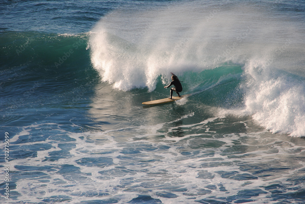 Professional surfer rides a wave in the ocean. Sopelana beach near Bilbao (Basque Country). Men catching waves in ocean. Tail slide water surf, action water board sport. Professional surfer rides a wave in the ocean. Sopelana beach near Bilbao (Basque Country). Men catching waves in ocean. Tail slide water surf, action water board sport.