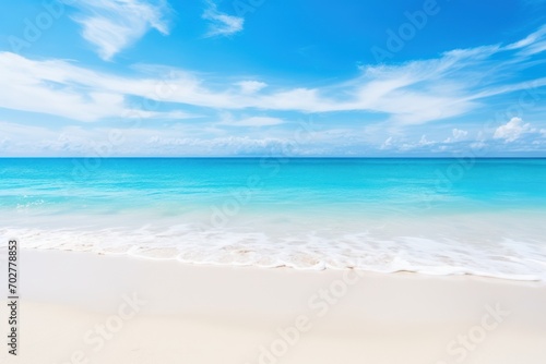  a sandy beach with clear blue water and a white sand beach under a blue sky with wispy clouds. © Shanti