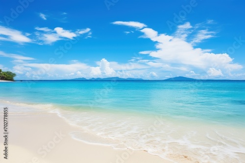  a sandy beach with clear blue water and a small island in the distance on a sunny day with clouds in the sky.