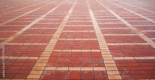 Red brick tile floor neatly arranged on a patterned texture background.