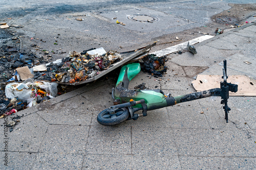Remains of an e-scooter and rubbish on New Year's Day following vandalism and arson.