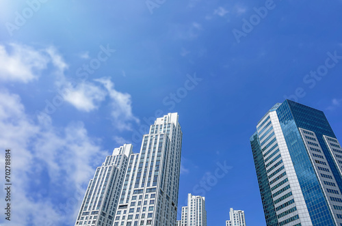 Buildings  skyscrapers against the blue sky. Bottom view. Outdoors. Business background. Day. Tall buildings against the sky. Megapolis. Copy space