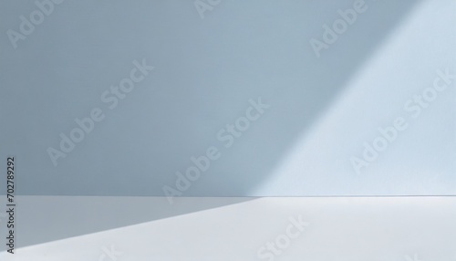 light minimalist geometric background image in gray and light blue tones with light and shadow from window for product presentation photo