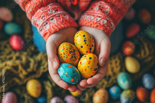Child toddler kid holding colored Easter egg in closeup hands. Religious holidays celebrating special moment to color decorate eggs tradition concept. Spring holiday celebration concept