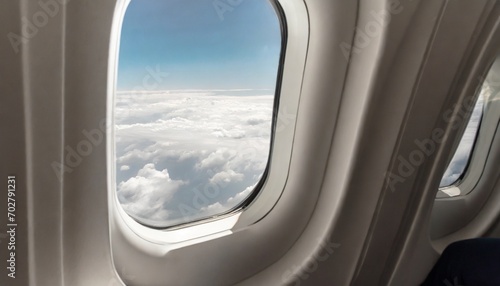 airplane interior or jet window with clouds and sky