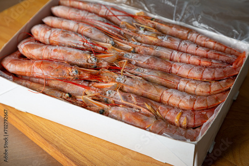 Box with frozen langoustines, shrimp