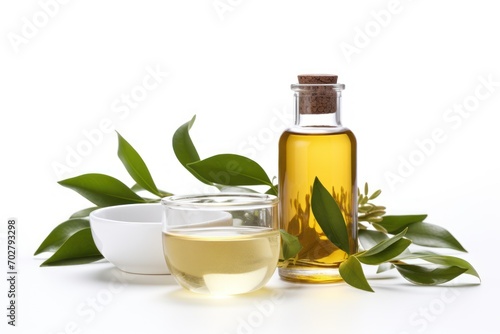  a bottle of olive oil next to a bowl of olives and a cup of tea on a white background.