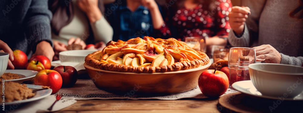 apple pie on the table against the backdrop of a family dinner. Selective focus.