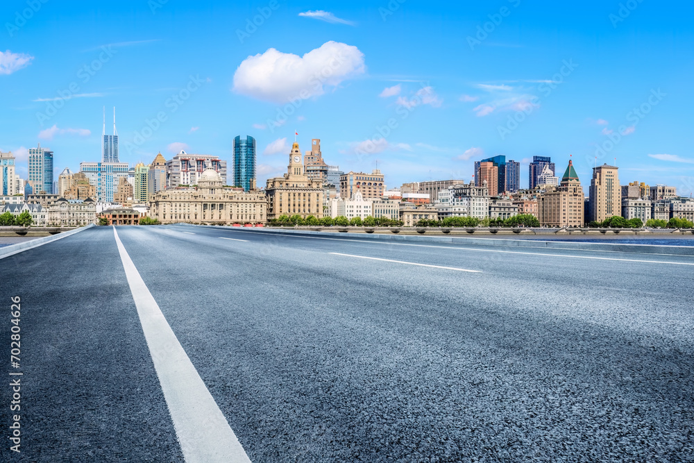 Empty asphalt road and city buildings skyline in Shanghai