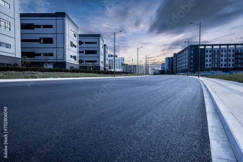 Empty asphalt road and industrial area building landscape
