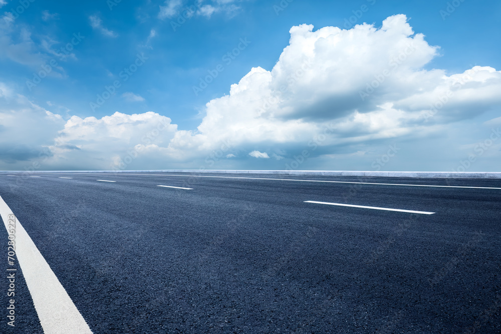 Fototapeta premium Empty asphalt road and sky clouds background