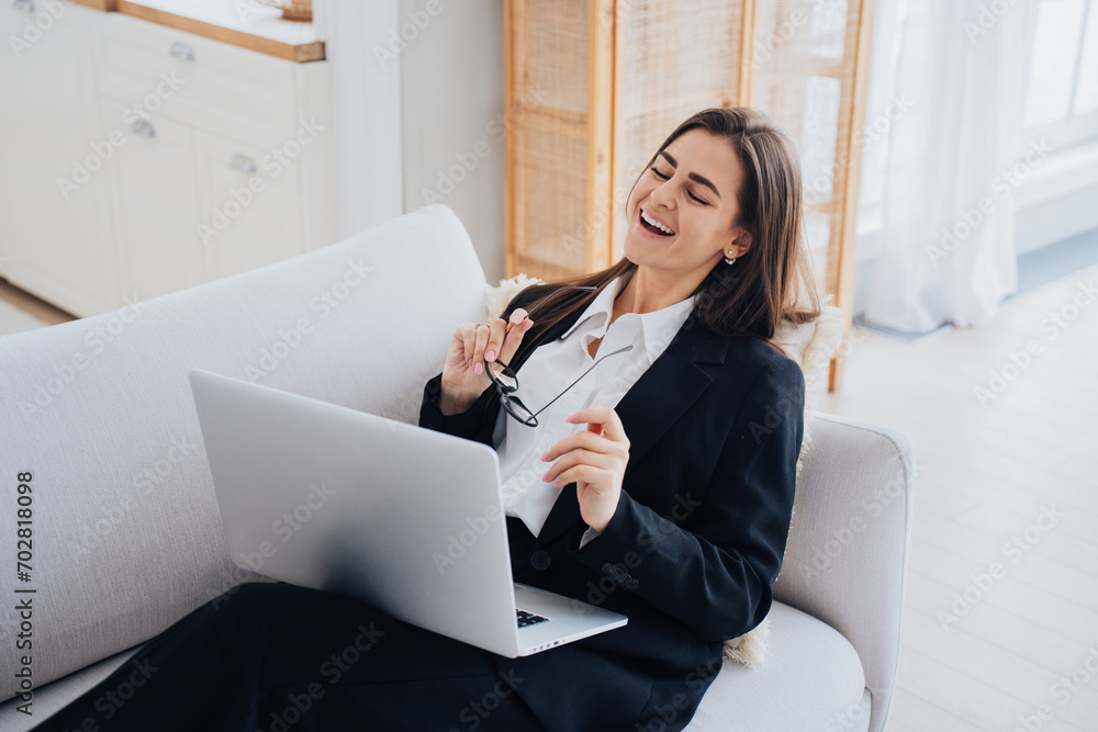 Joyful businesswoman laughing during a break from work at home Joyful businesswoman laughing during a break from work at home