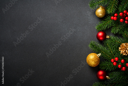 Black christmas flat lay background. Christmas tree with holidays decorations.