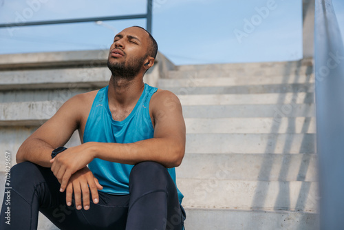 Young man in sportswear on the stairs after a good workout