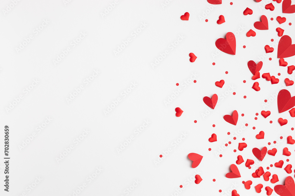 Valentine day festive greeting card border of mixed red hearts on white background top view. Flat lay style.
