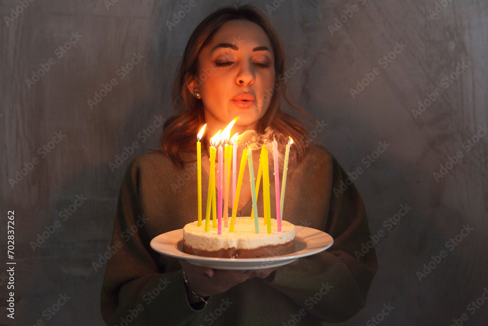 Young smiling woman holding homemade birthday cake pie with burning candles Young smiling woman holding homemade birthday cake pie with burning candles