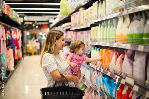 фотографія Cheerful mother and baby spending time in shopping in shopping centre