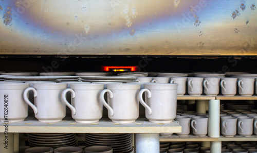 rows of white identical mugs visited in a muffle kiln at a porcelain factory in Likino-Dulevo in the Moscow region