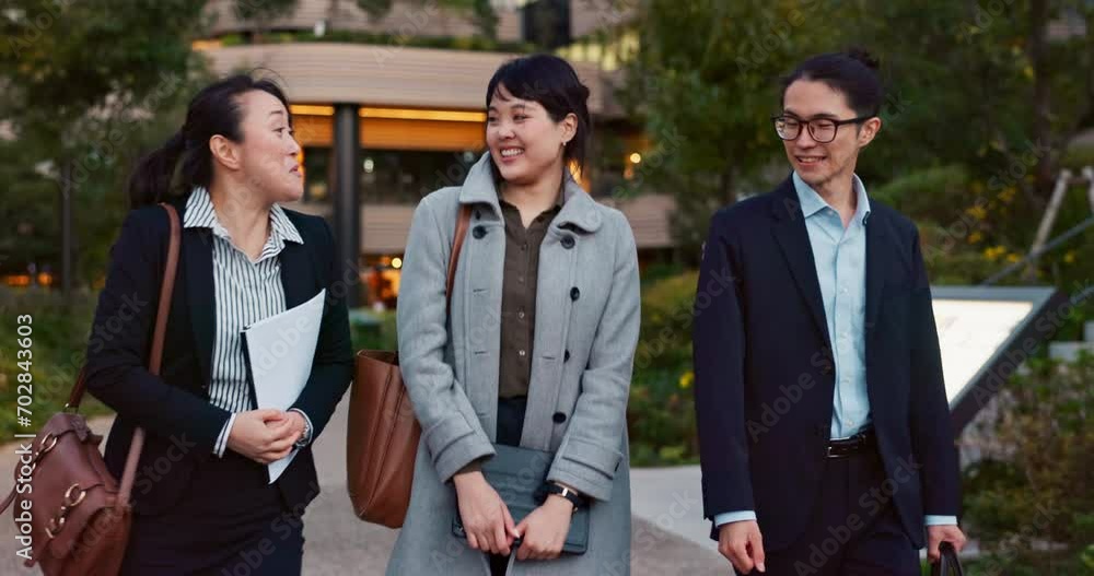 Walking, conversation and business people in the city talking for communication or bonding. Smile, discussion and professional Asian colleagues speaking and laughing together commuting in town. Walking, conversation and business people in the city talking for communication or bonding. Smile, discussion and professional Asian colleagues speaking and laughing together commuting in town.