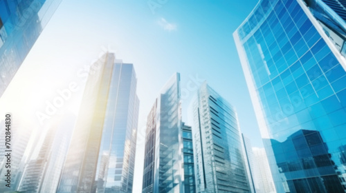 Modern office building with blue sky, and glass facades. Economy, finances, business activity concept, Eco-friendly building in the city, blurred image