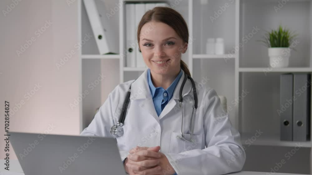 A patient health professional uses information to develop individualized treatment strategies and support for patients. Female doctor looking at camera with smile, smiling. Medic at the doctors table A patient health professional uses information to develop individualized treatment strategies and support for patients. Female doctor looking at camera with smile, smiling. Medic at the doctors table