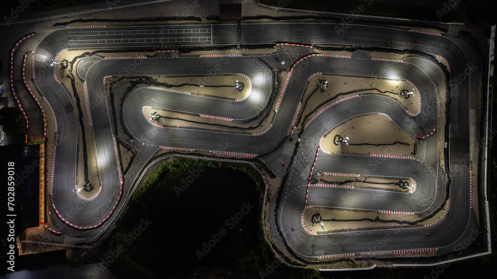 Aerial top view race kart track at night, Track for auto racing top view, Car race asphalt and curve street circuit, Aerial view asphalt race track at night. - obrazy, fototapety, plakaty 