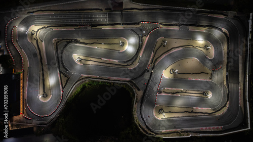 Aerial top view race kart track at night, Track for auto racing top view, Car race asphalt and curve street circuit, Aerial view asphalt race track at night. © Darunrat