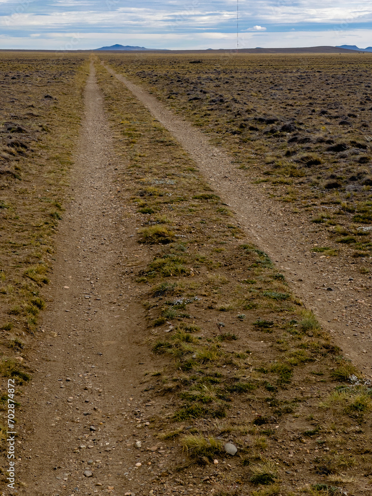 lonely road on a cloudy country day that disappears into the horizon lonely road on a cloudy country day that disappears into the horizon