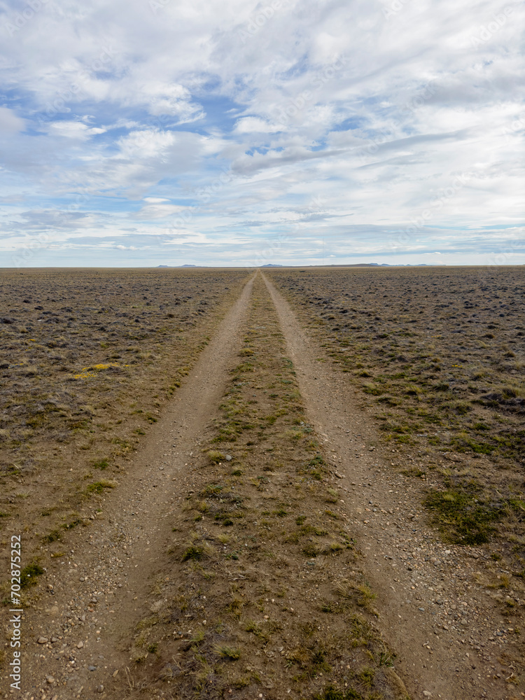 lonely road on a cloudy country day that disappears into the horizon lonely road on a cloudy country day that disappears into the horizon