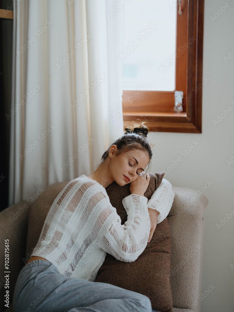 Woman in sweater and home pants relaxing lying on the couch at home, cozy day off in comfort, real lifestyle with a smile. Woman in sweater and home pants relaxing lying on the couch at home, cozy day off in comfort, real lifestyle with a smile.